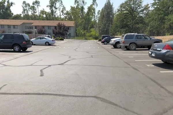 a view of street with parked cars