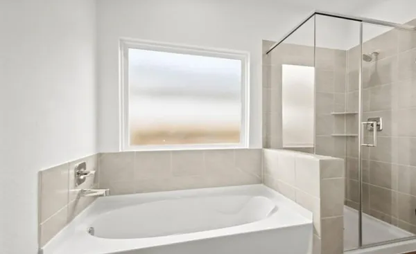 a white bath tub sitting next to a shower