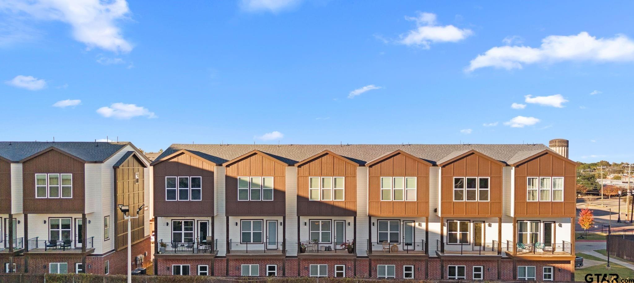 546 West Erwin Street Tyler, TX 75702 - Photo 24 of 31 a front view of a residential apartment building with a yard
