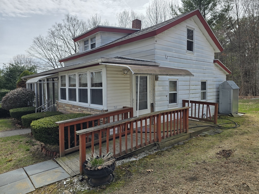 205 Hardwick Road Hardwick, MA 01031 - Photo 5 of 29 a view of a house with wooden deck and furniture