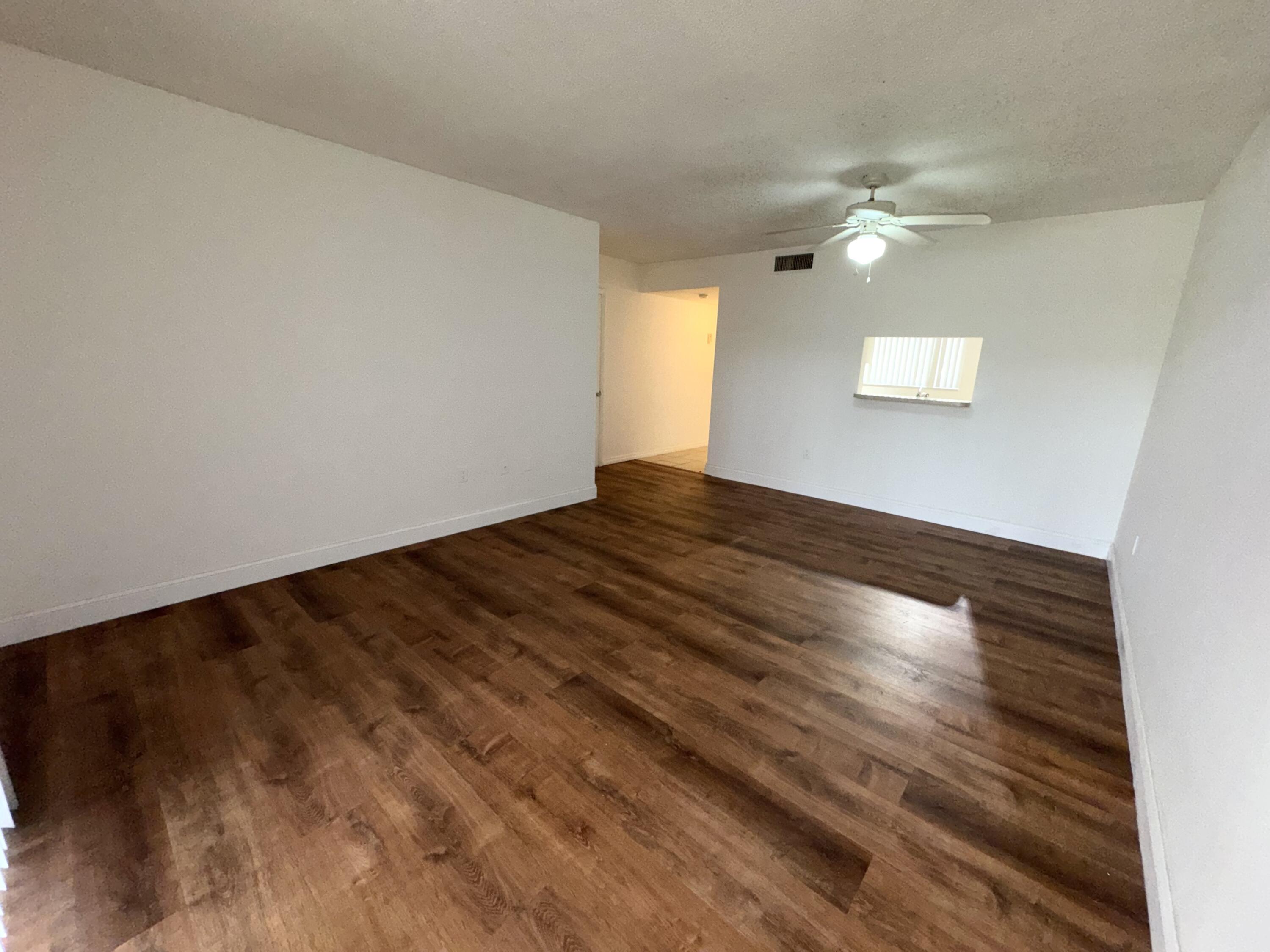 701 North Pine Island Road, Unit 105 Plantation, FL 33324 - Photo 11 of 23 a view of empty room with wooden floor and fan
