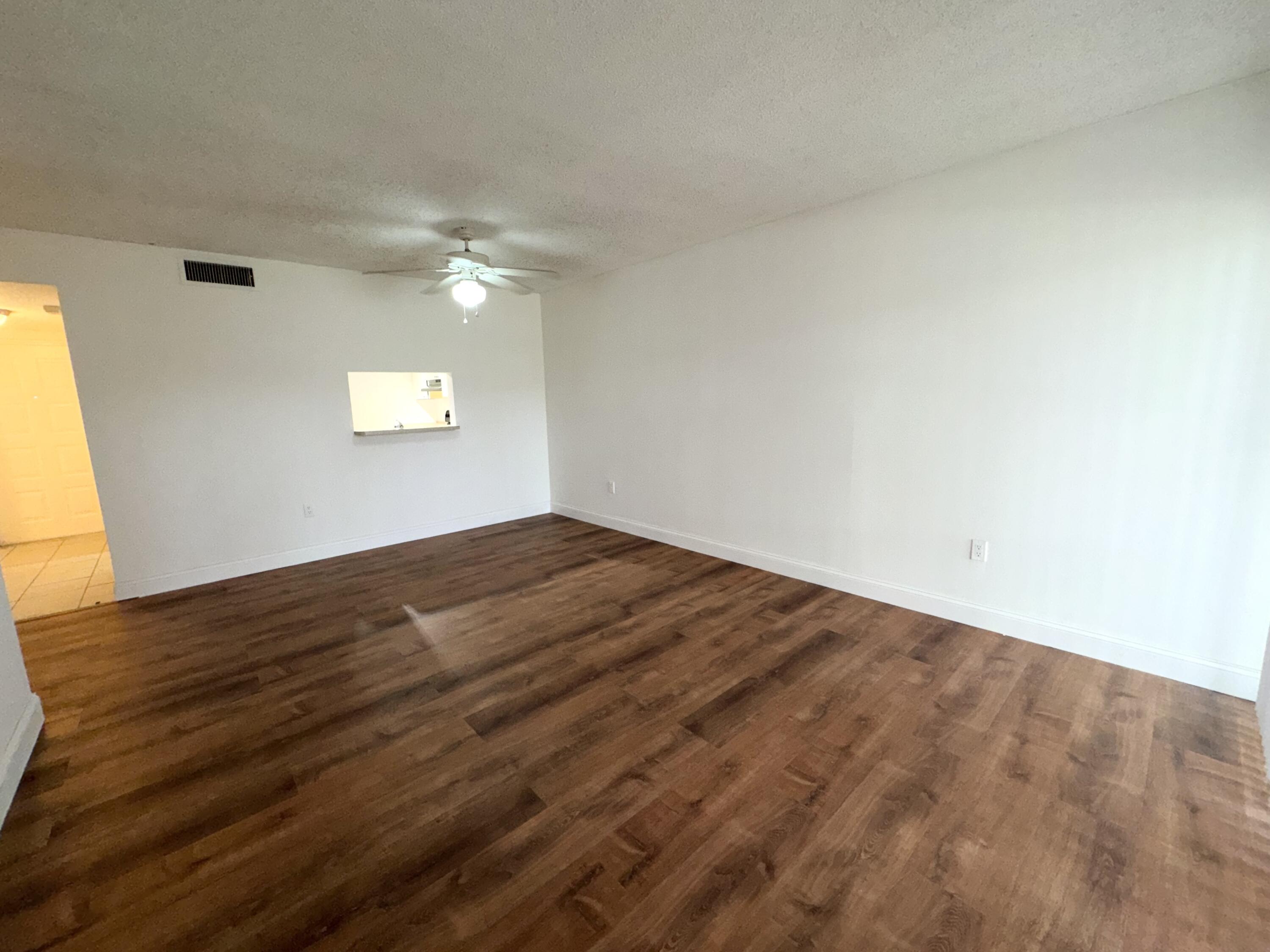 701 North Pine Island Road, Unit 105 Plantation, FL 33324 - Photo 12 of 23 a view of empty room with wooden floor and fan