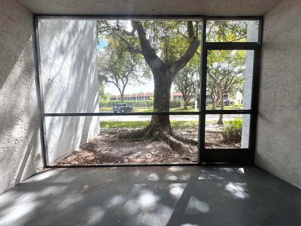 a view of empty room with large windows