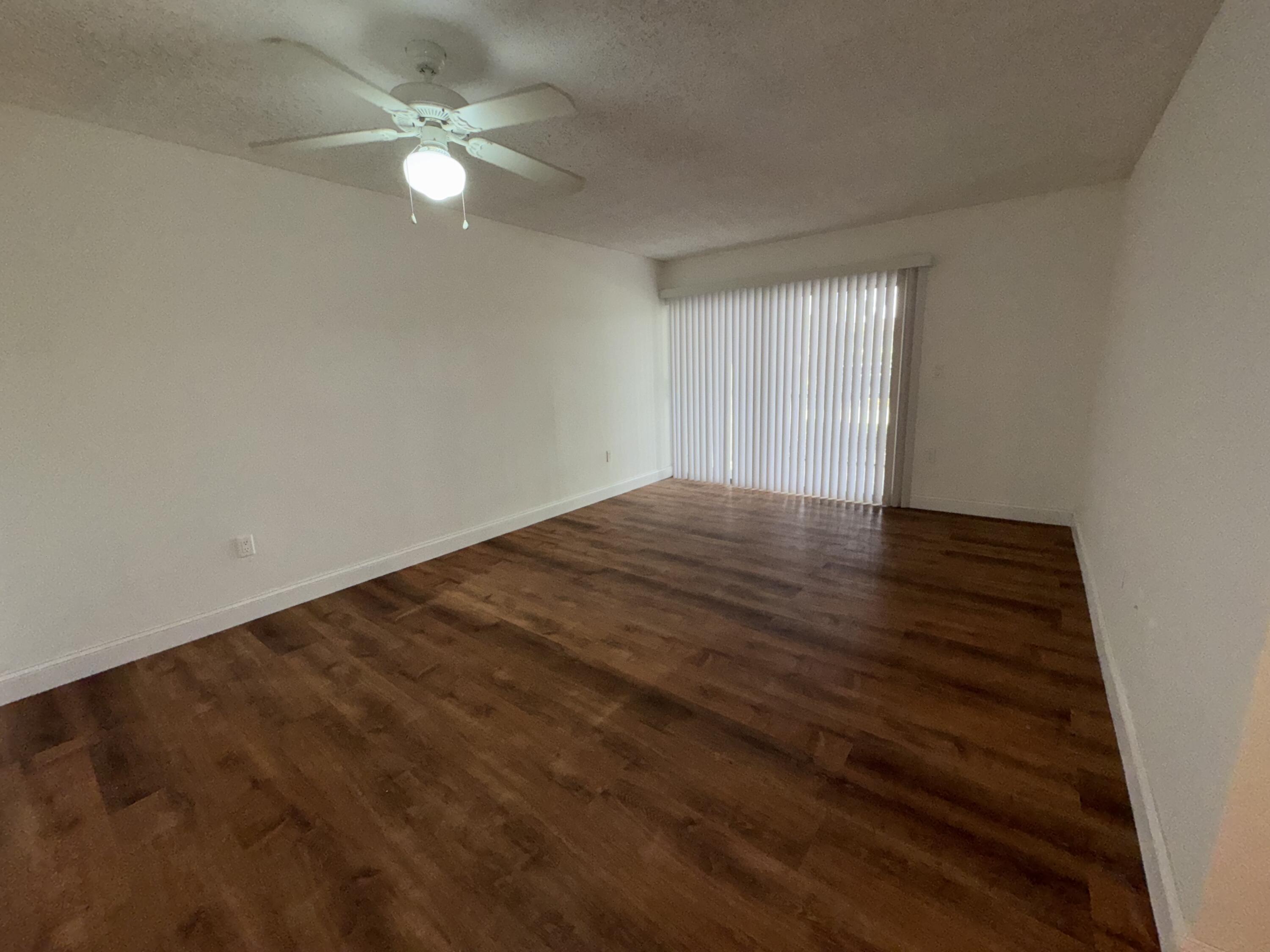 701 North Pine Island Road, Unit 105 Plantation, FL 33324 - Photo 14 of 23 wooden floor in an empty room with a window