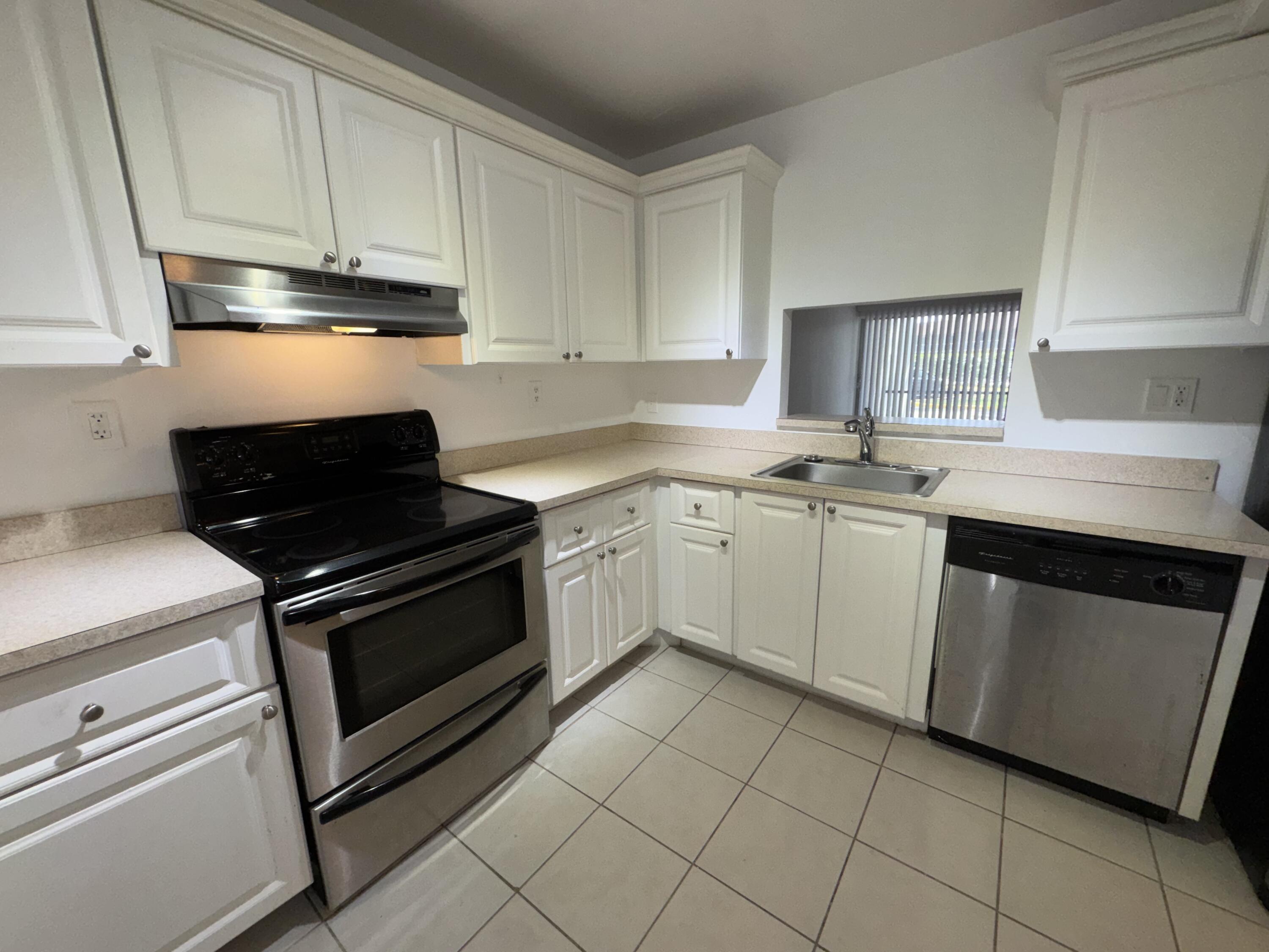 701 North Pine Island Road, Unit 105 Plantation, FL 33324 - Photo 15 of 23 a kitchen with cabinets appliances and a sink