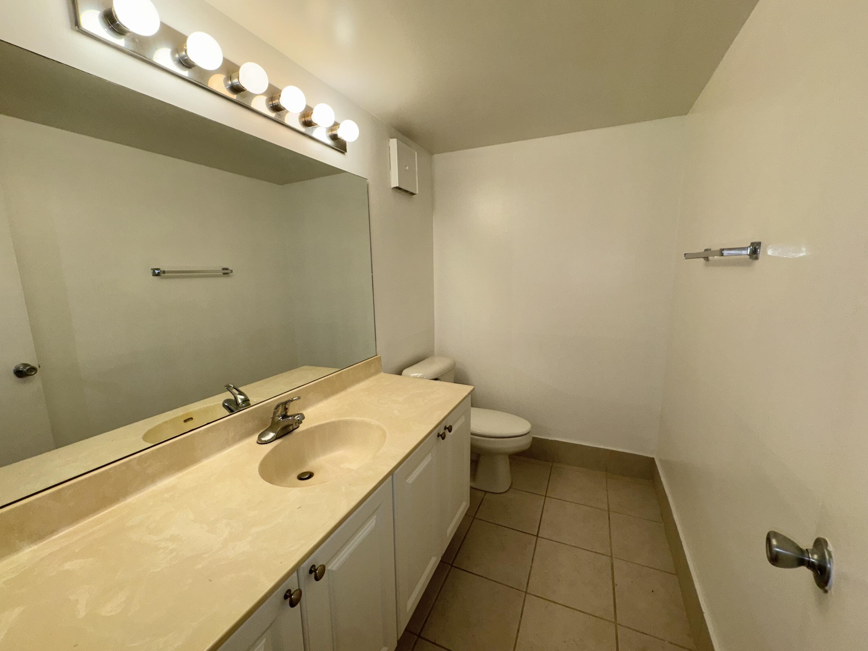701 North Pine Island Road, Unit 105 Plantation, FL 33324 - Photo 16 of 23 a bathroom with a sink a toilet and shower