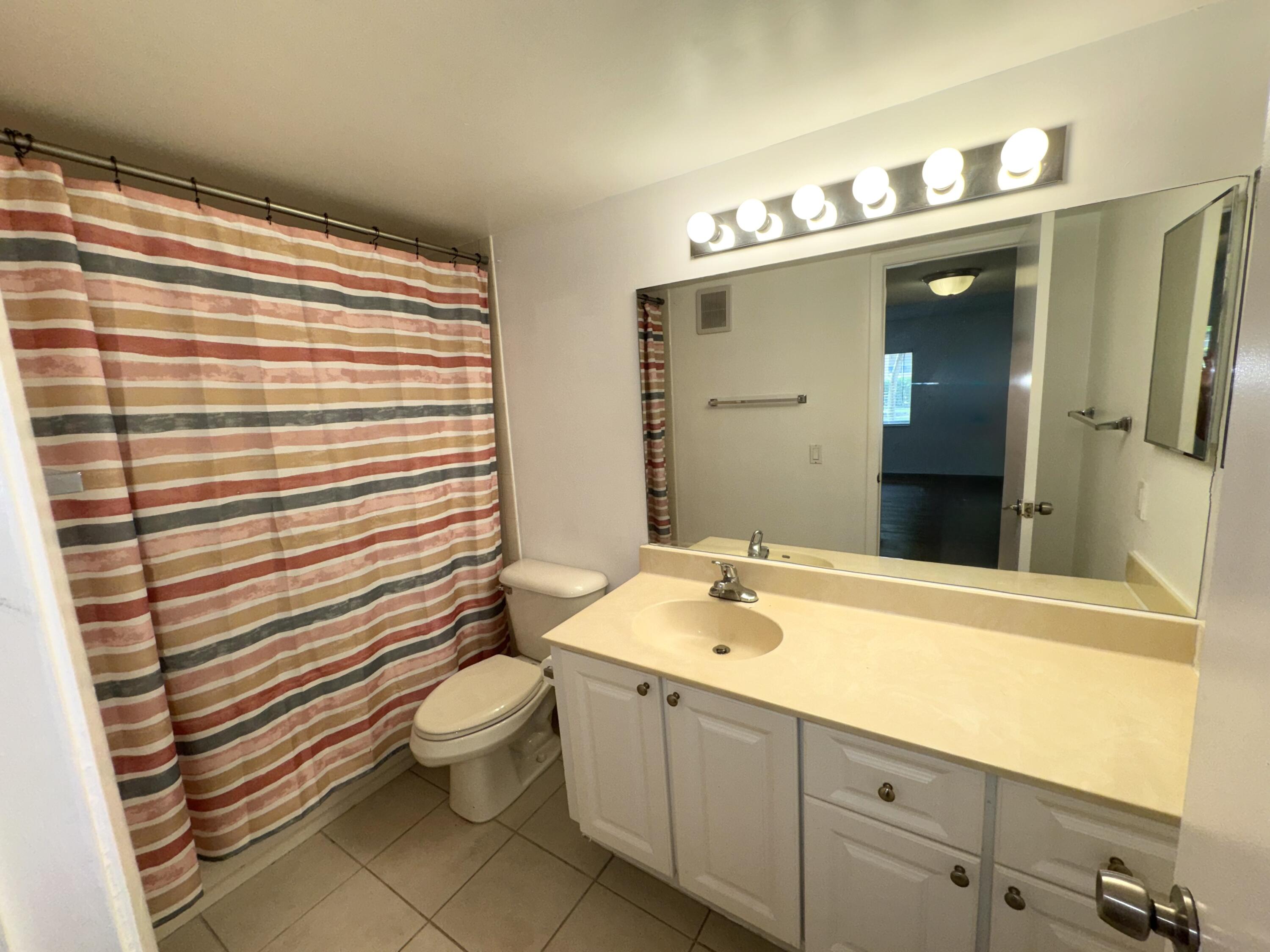 701 North Pine Island Road, Unit 105 Plantation, FL 33324 - Photo 5 of 23 a bathroom with a sink a toilet and shower