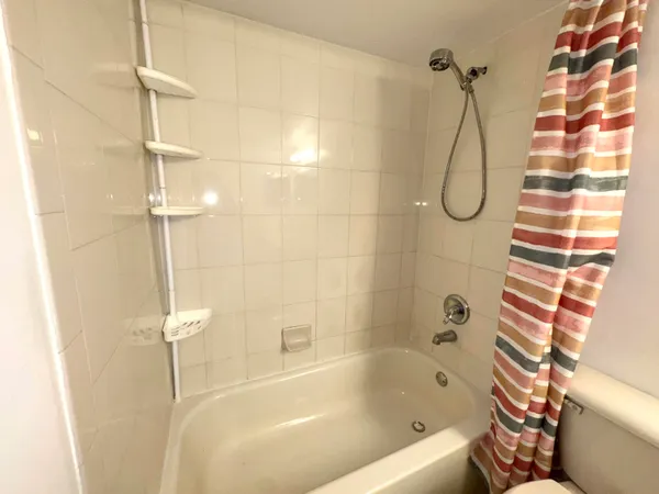 a bathroom with a bath tub with a shower