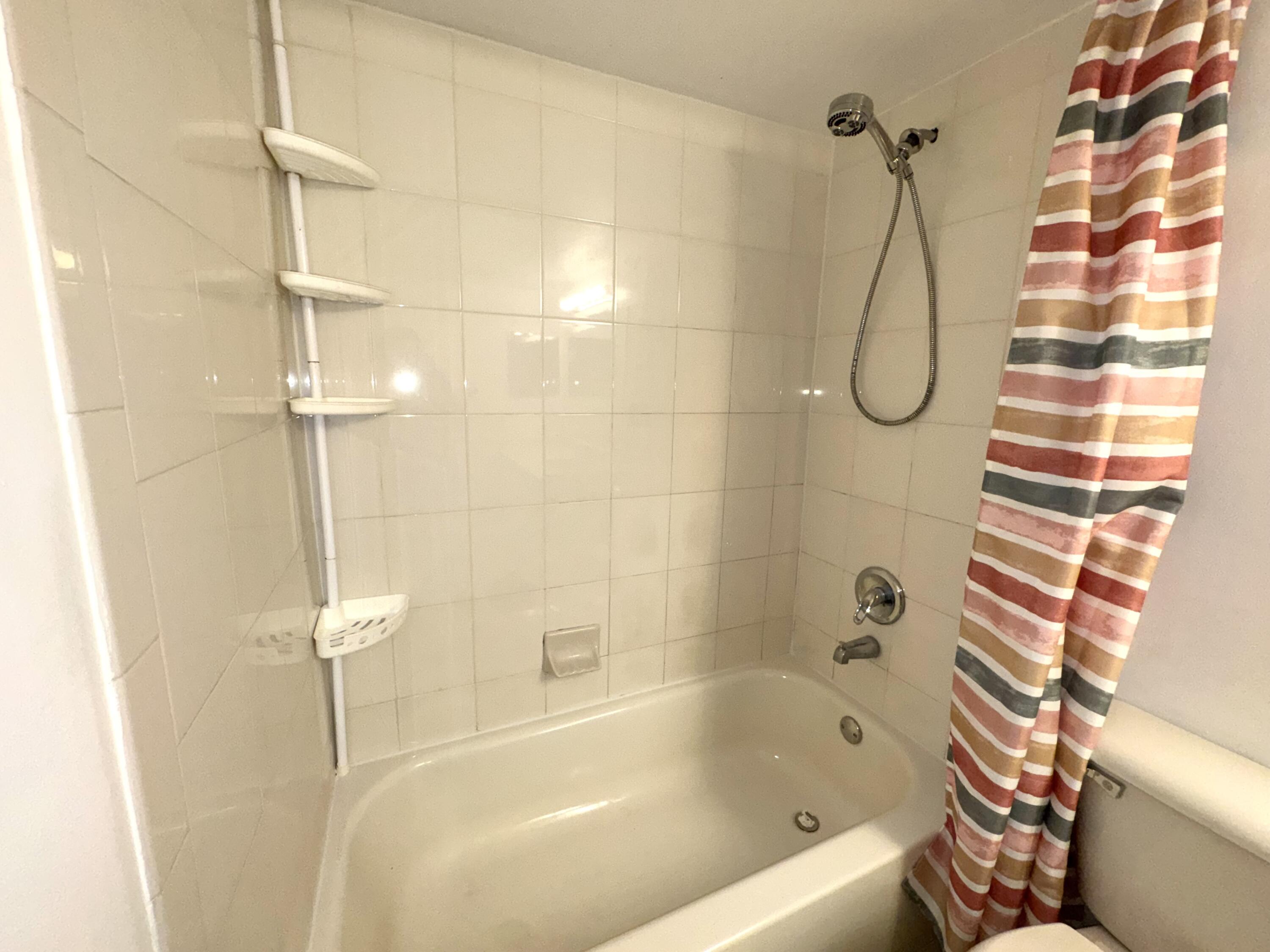 701 North Pine Island Road, Unit 105 Plantation, FL 33324 - Photo 6 of 23 a bathroom with a bath tub with a shower