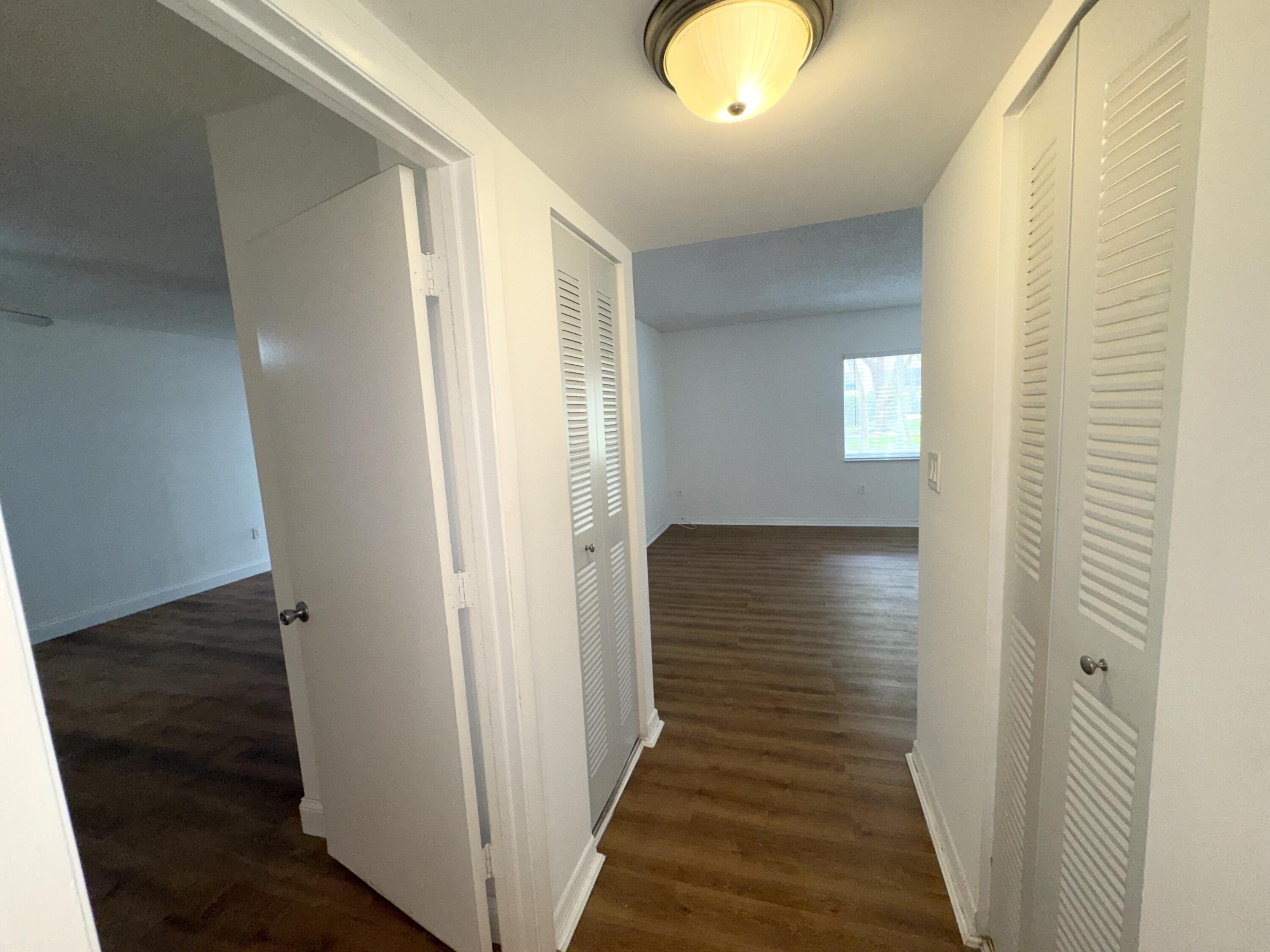 701 North Pine Island Road, Unit 105 Plantation, FL 33324 - Photo 7 of 23 a view of a hallway with wooden floor and staircase