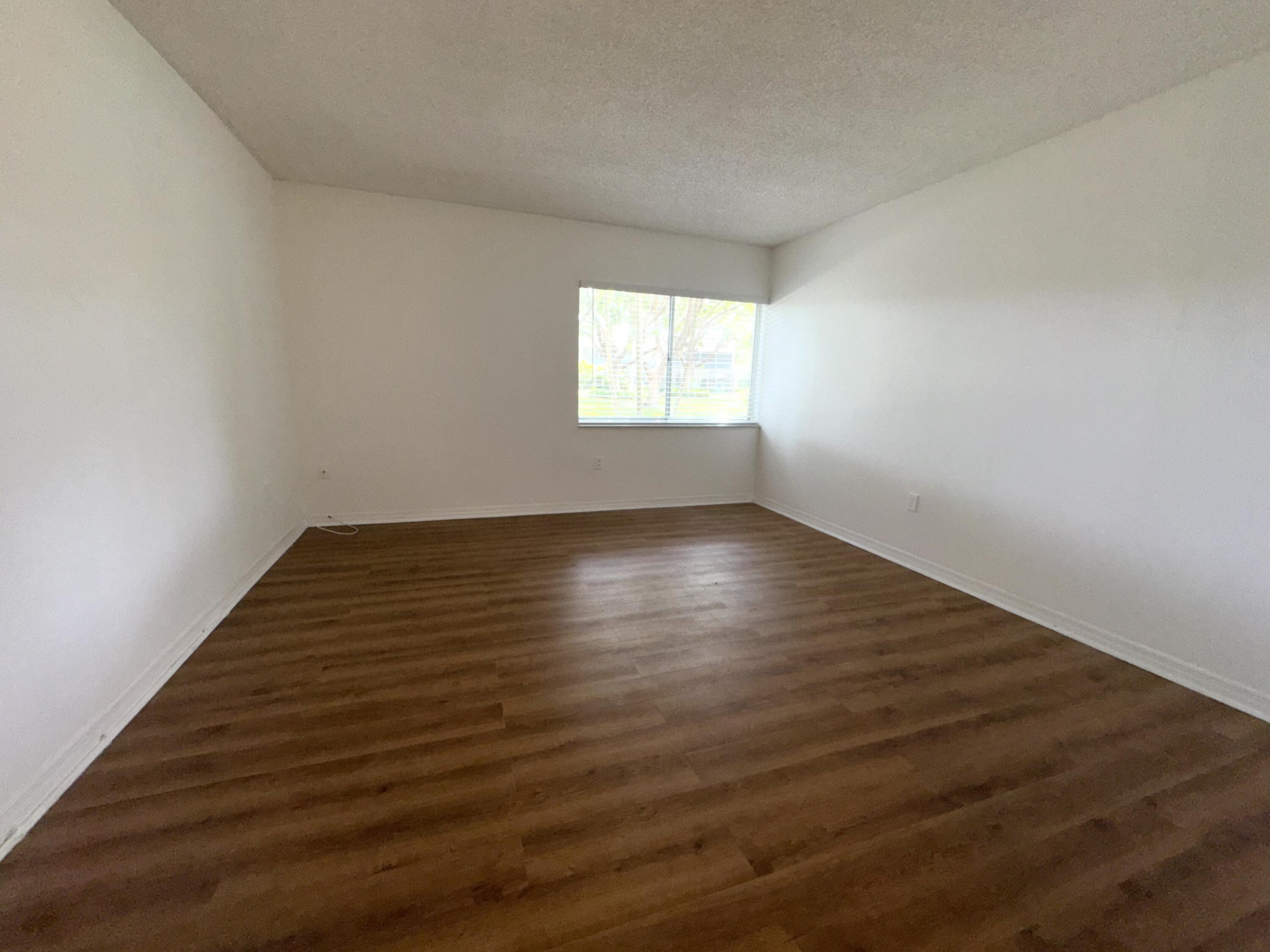 701 North Pine Island Road, Unit 105 Plantation, FL 33324 - Photo 9 of 23 wooden floor in an empty room