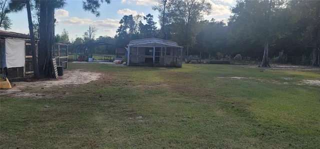 a backyard of a house with table and chairs