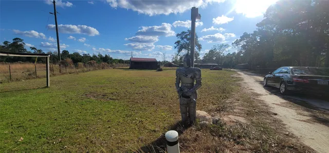 a view of yard with swimming pool