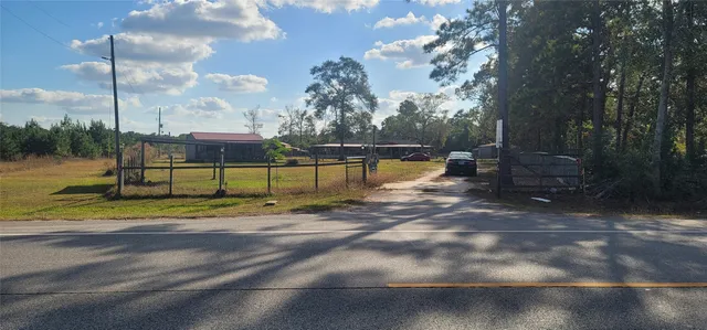 a view of a street with trees on both side of it
