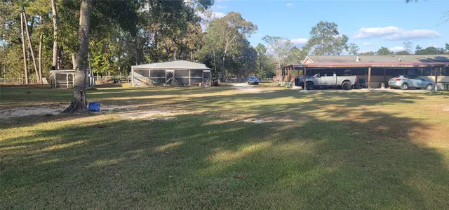 a front view of a building with a yard