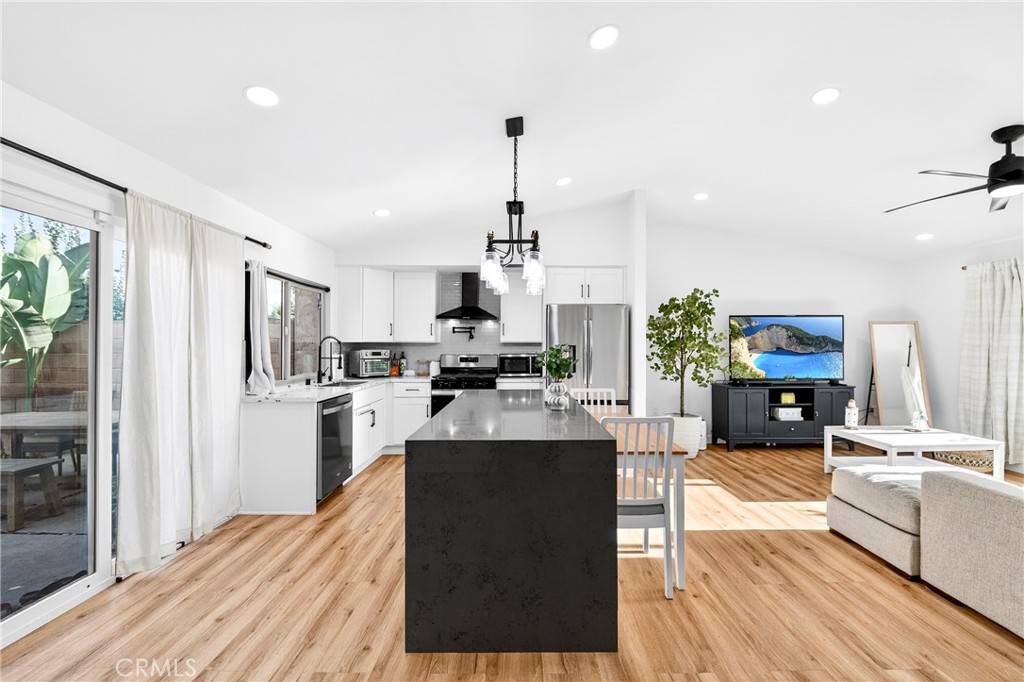 5050 Brooklawn Place Riverside, CA 92504 - Photo 13 of 44 a living room with kitchen island granite countertop furniture and a kitchen view