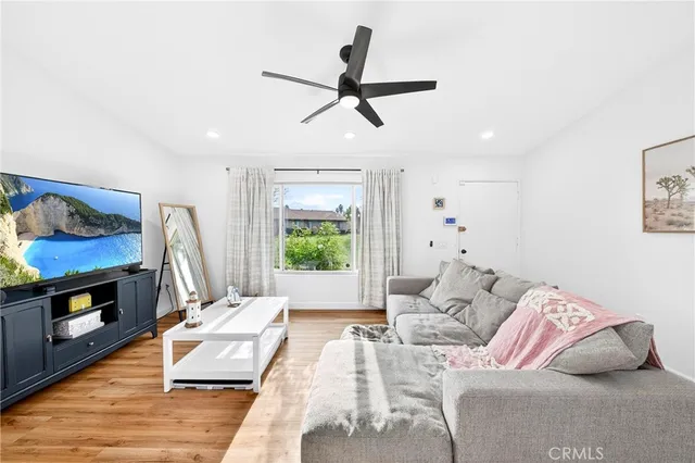 a living room with furniture fireplace and flat screen tv