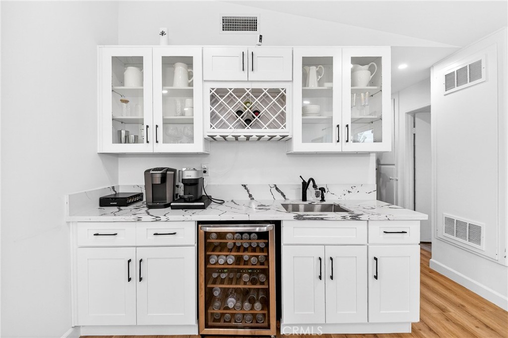 5050 Brooklawn Place Riverside, CA 92504 - Photo 16 of 44 a kitchen with stainless steel appliances granite countertop a sink stove and cabinets