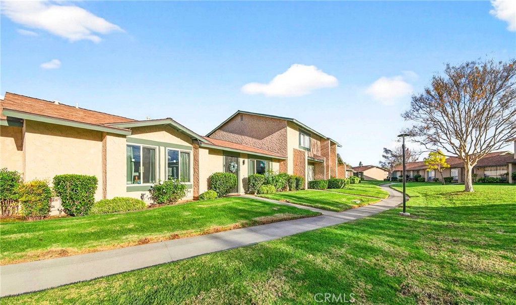 5050 Brooklawn Place Riverside, CA 92504 - Photo 2 of 44 a front view of a house with a yard and trees