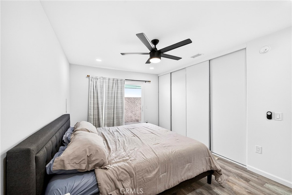 5050 Brooklawn Place Riverside, CA 92504 - Photo 21 of 44 a bedroom with a bed and a ceiling fan