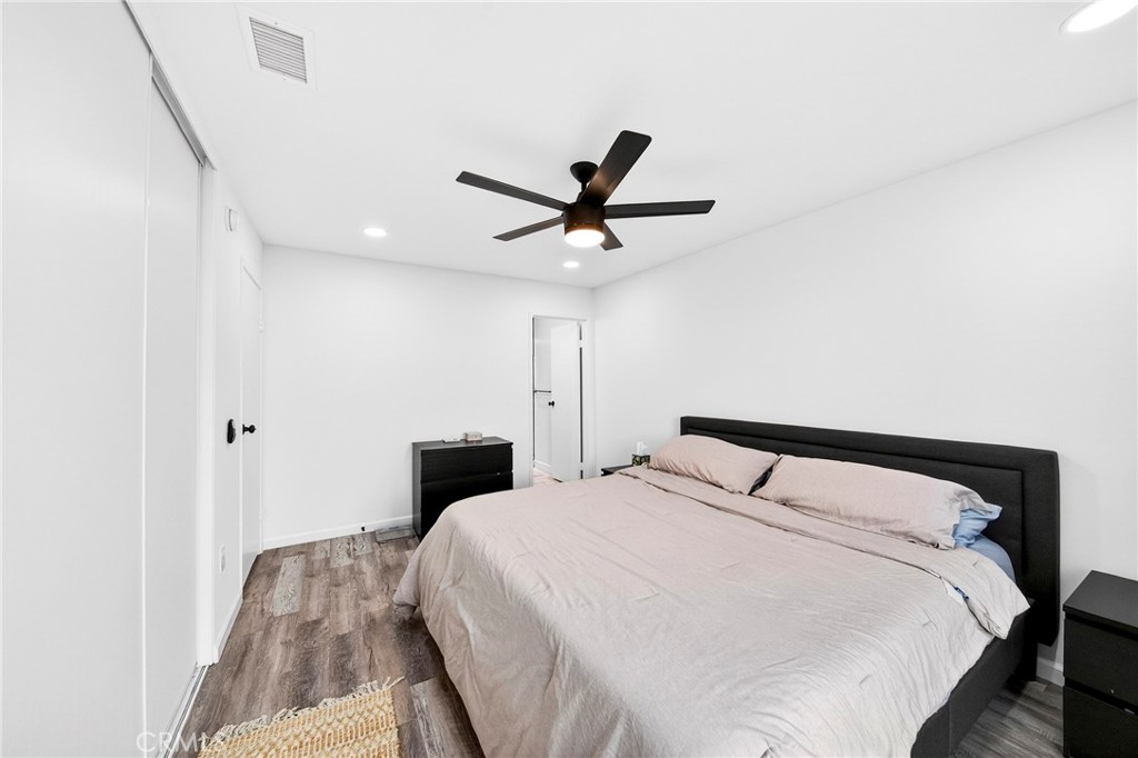 5050 Brooklawn Place Riverside, CA 92504 - Photo 22 of 44 a bedroom with a bed and a ceiling fan