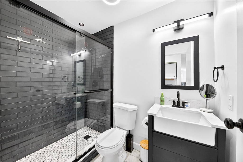 5050 Brooklawn Place Riverside, CA 92504 - Photo 23 of 44 a bathroom with a sink a toilet and shower