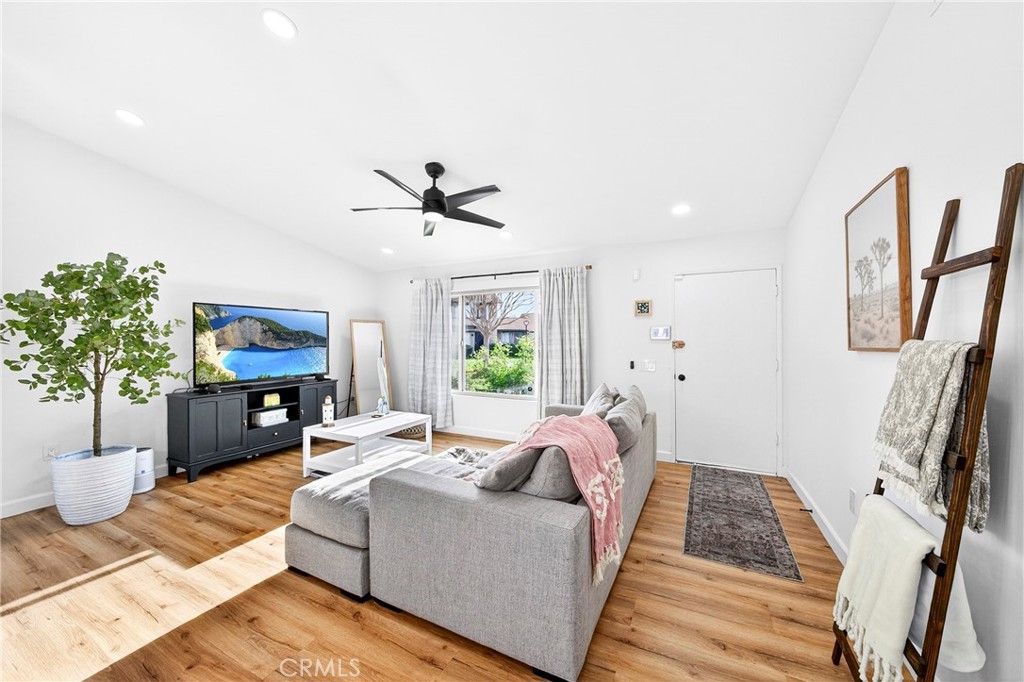 5050 Brooklawn Place Riverside, CA 92504 - Photo 5 of 44 a living room with furniture fireplace and a potted plant