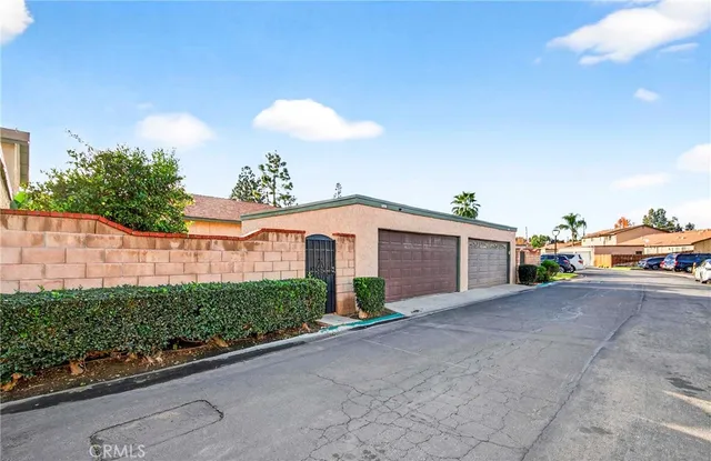 a view of a house with a yard and potted plants