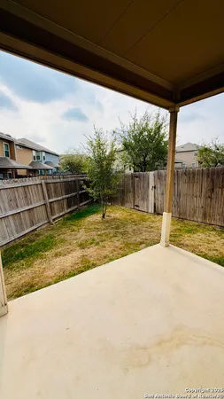 a view of house with backyard and porch