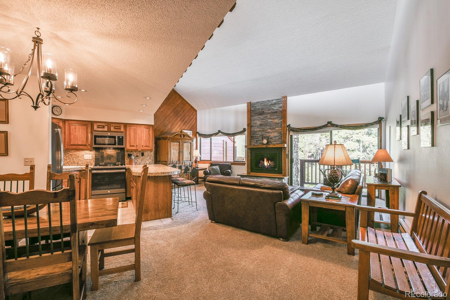 a room with lots of wooden furniture and a view of living room