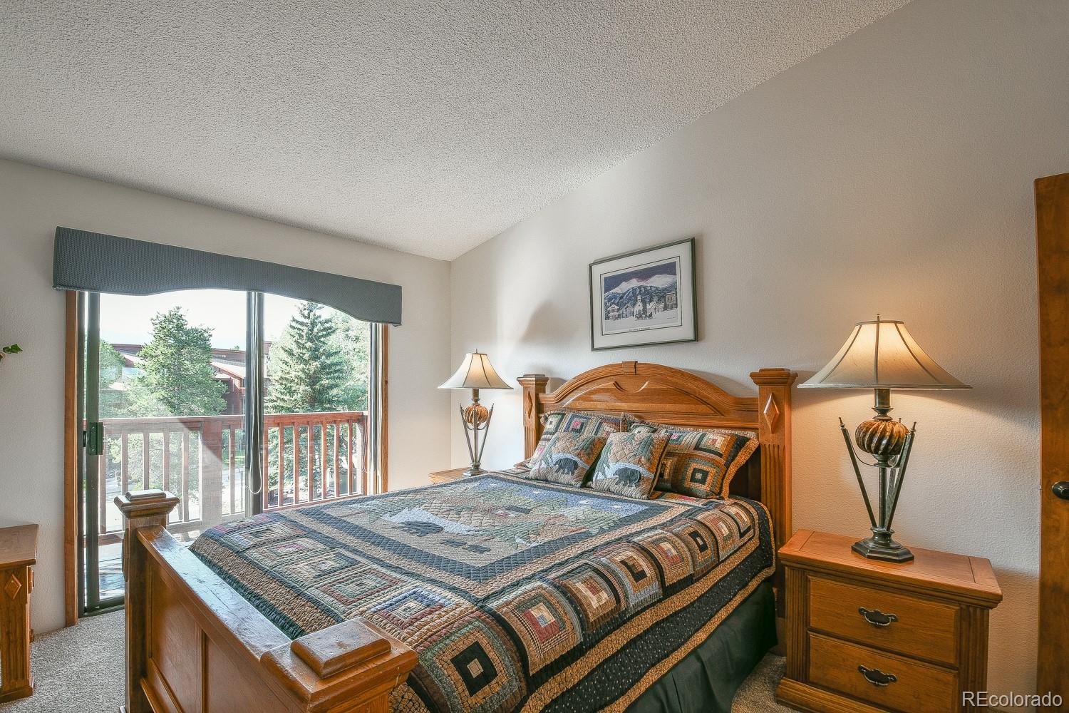 400 4 O Clock Road, Unit E Breckenridge, CO 80424 - Photo 18 of 34 a bedroom with a bed and a dresser next to a window