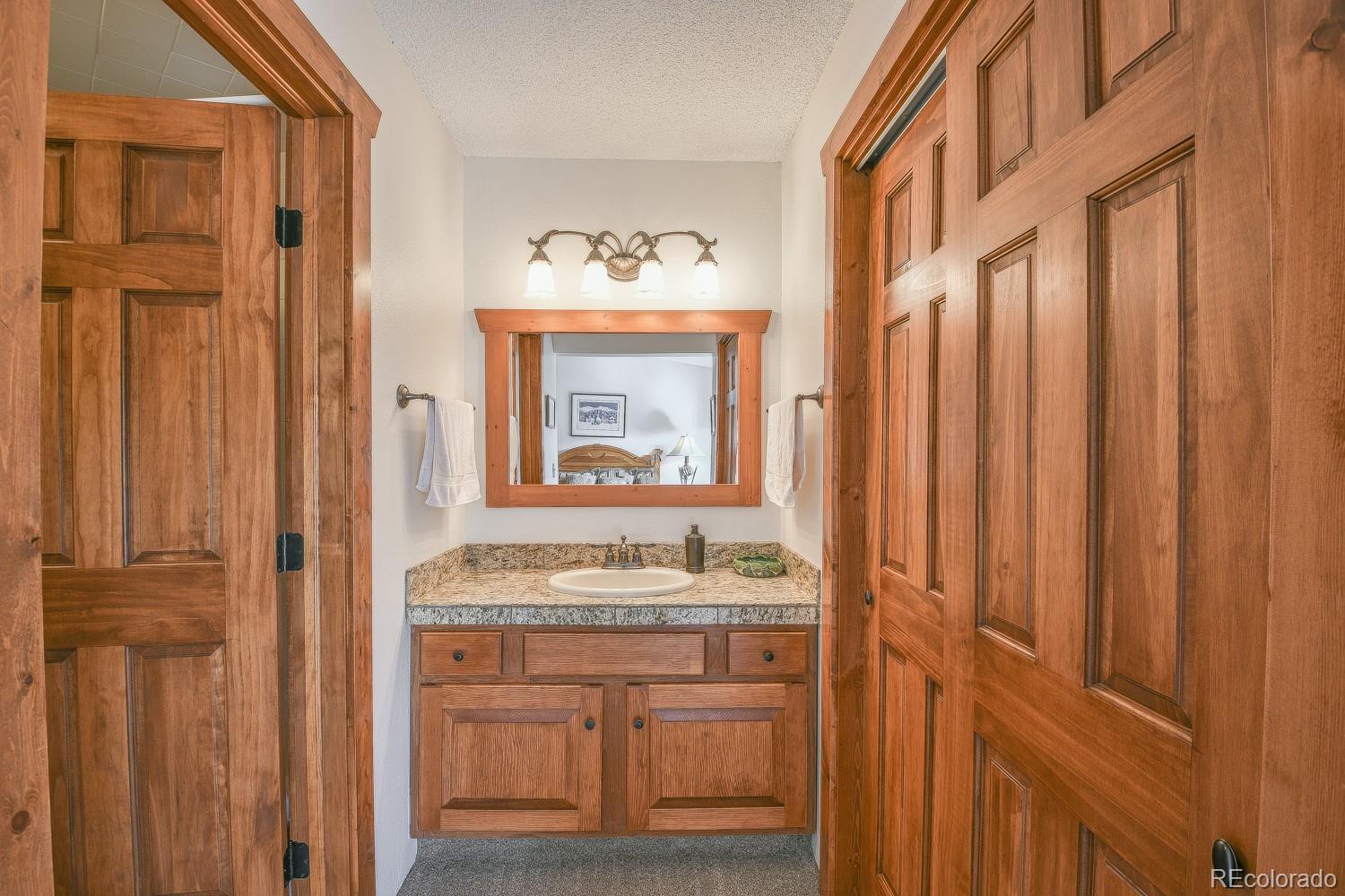 400 4 O Clock Road, Unit E Breckenridge, CO 80424 - Photo 20 of 34 a bathroom with a sink and a mirror
