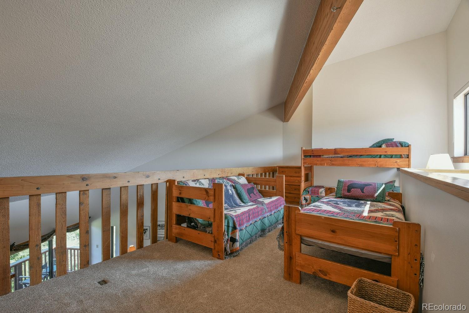 400 4 O Clock Road, Unit E Breckenridge, CO 80424 - Photo 29 of 34 a bedroom with furniture and a book shelf