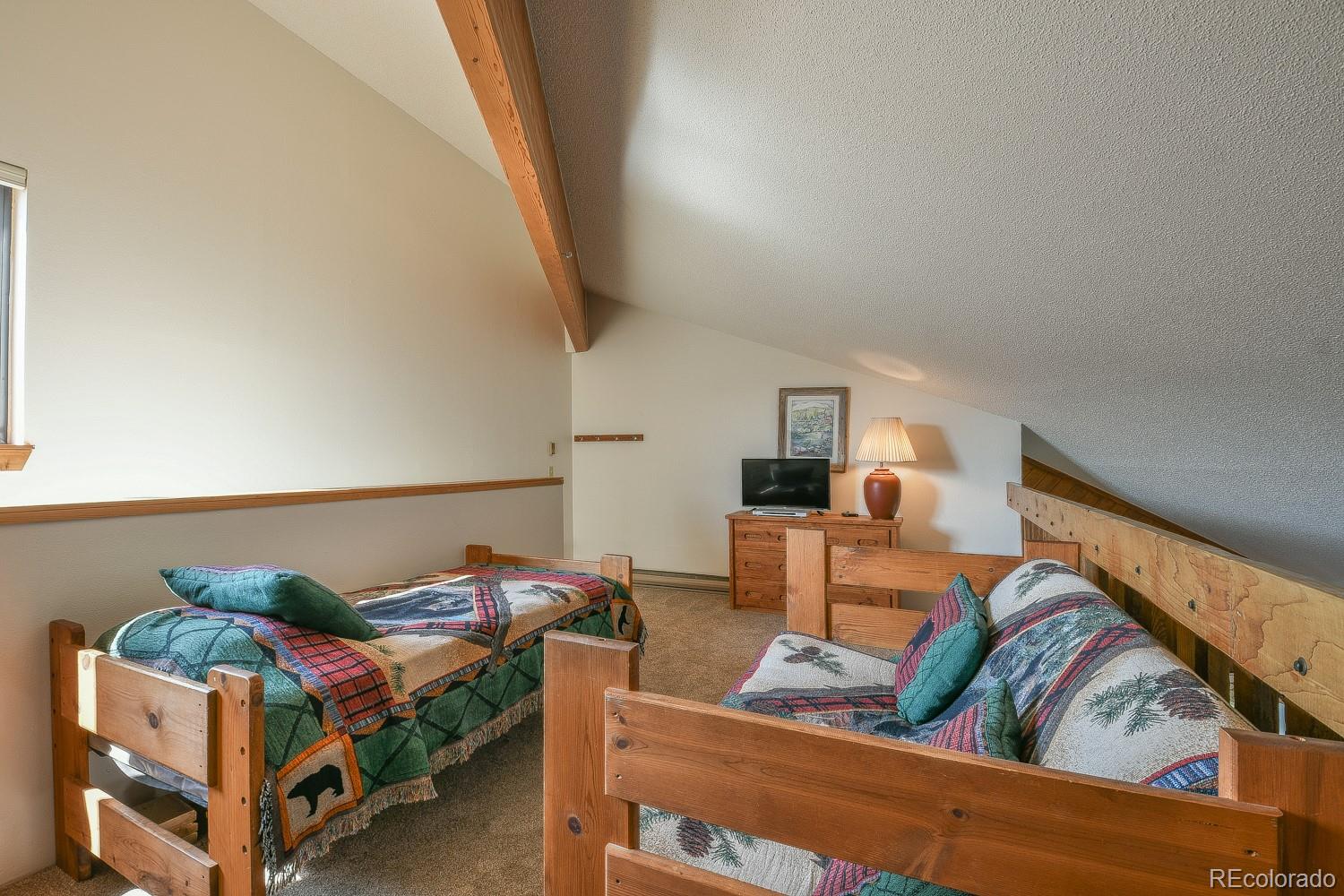 400 4 O Clock Road, Unit E Breckenridge, CO 80424 - Photo 30 of 34 a bedroom with furniture and a couch