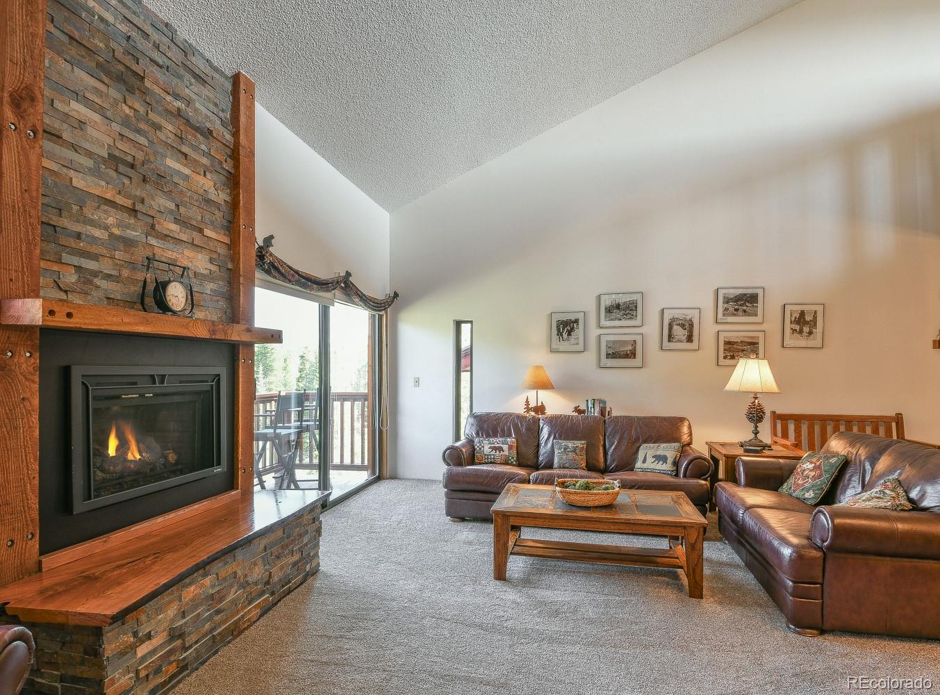 400 4 O Clock Road, Unit E Breckenridge, CO 80424 - Photo 3 of 34 a living room with furniture a flat screen tv and a fireplace