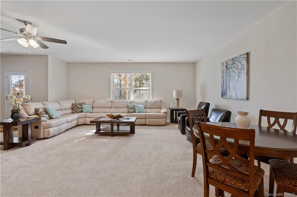 5318 Meadowcroft Way Fort Mill, SC 29708 - Photo 35 of 48 a living room with furniture and a dining table with kitchen view
