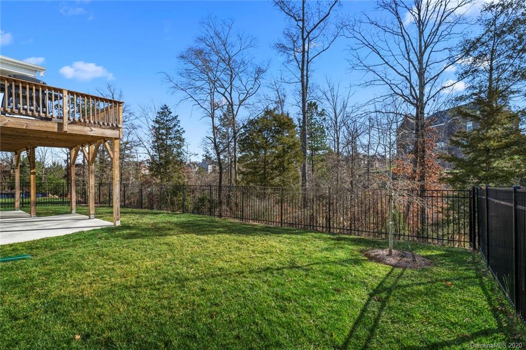 5318 Meadowcroft Way Fort Mill, SC 29708 - Photo 39 of 48 a view of a backyard with large trees and wooden fence