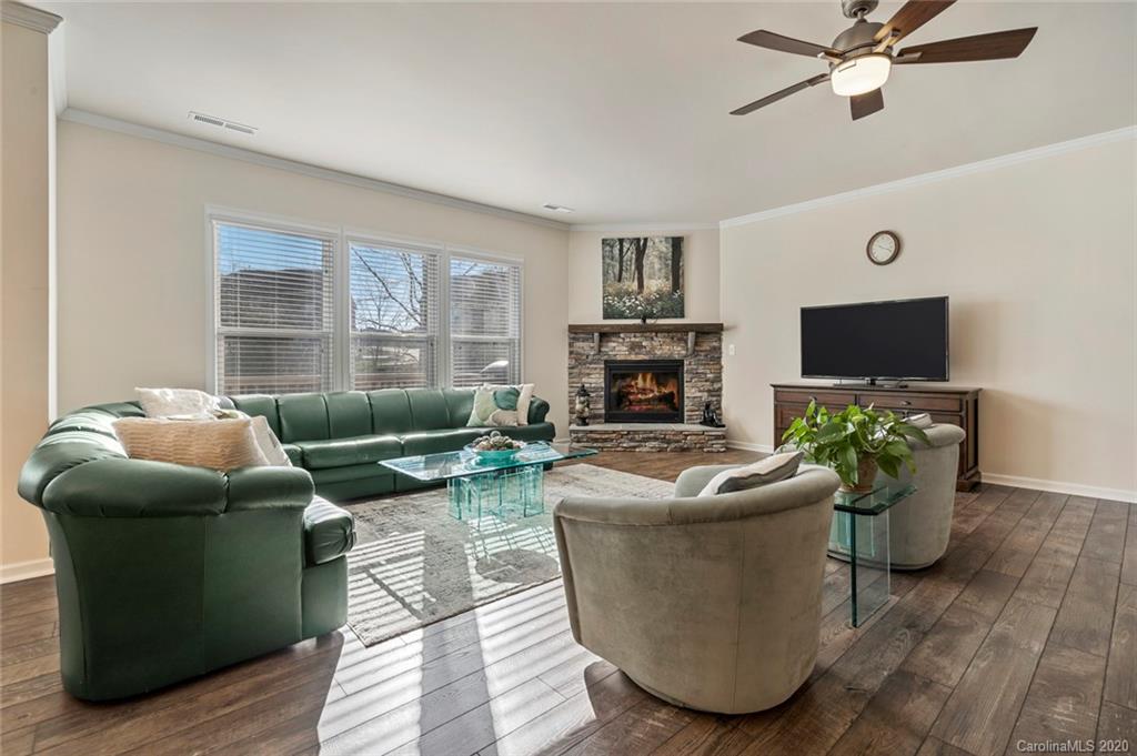 5318 Meadowcroft Way Fort Mill, SC 29708 - Photo 8 of 48 a living room with furniture a flat screen tv and a fireplace