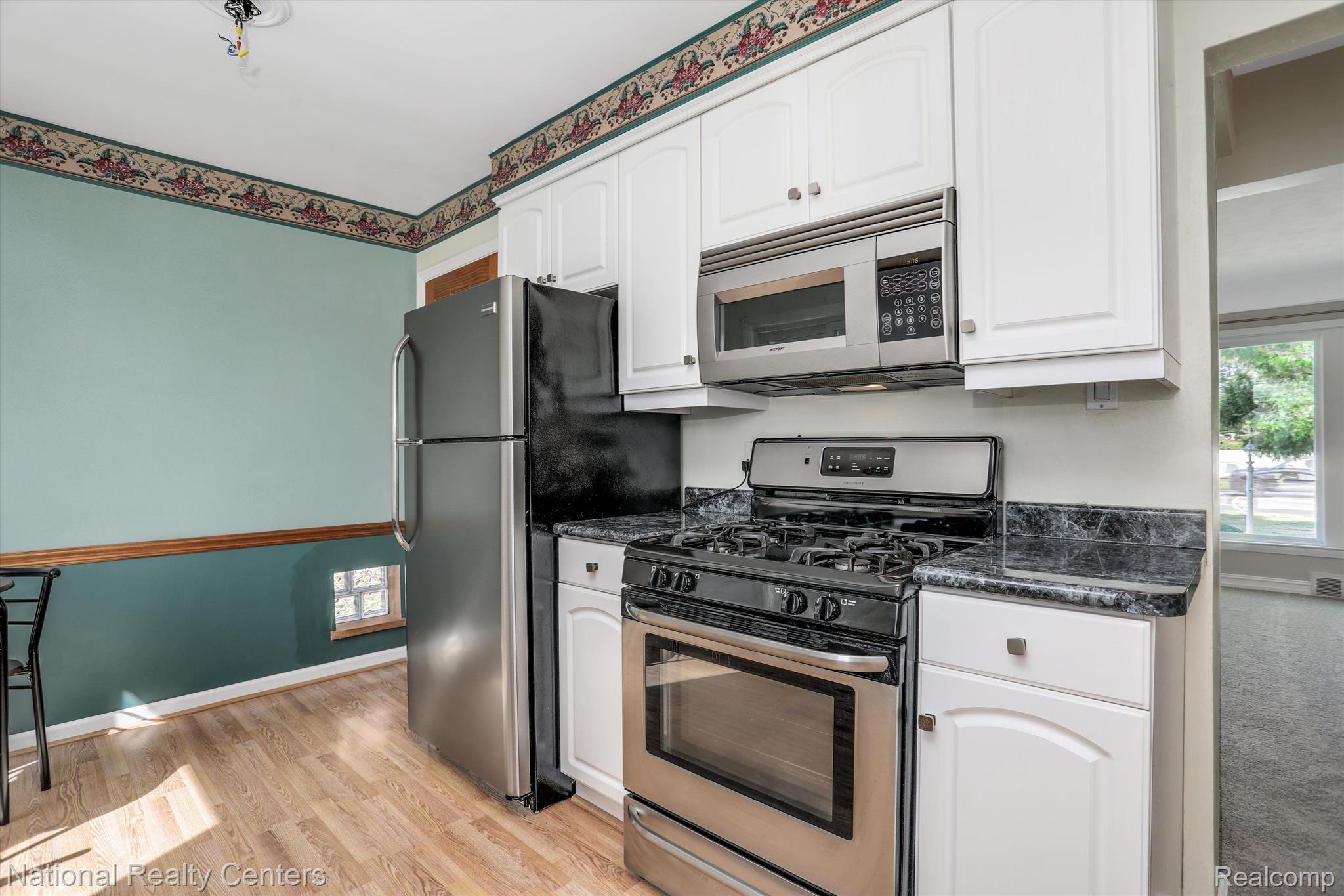 6037 Inkster Road Garden City, MI 48135 - Photo 7 of 26 Stainless steel appliances and white cabinetry