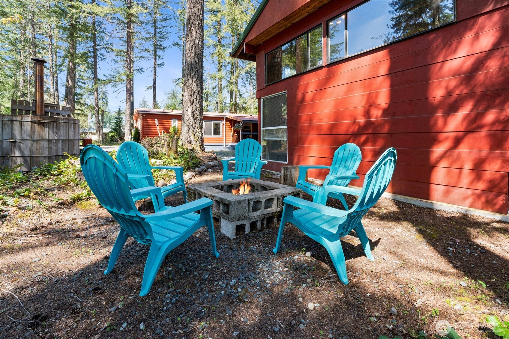 271 Skate Creek Road North Ashford, WA 98304 - Photo 30 of 40 a backyard of a house with a fountain table and chairs