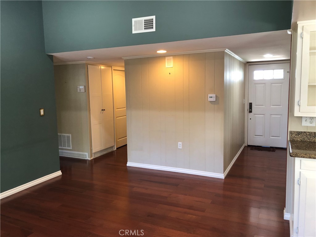 11402 Donovan Road Los Alamitos, CA 90720 - Photo 14 of 44 an empty room with wooden floor and windows