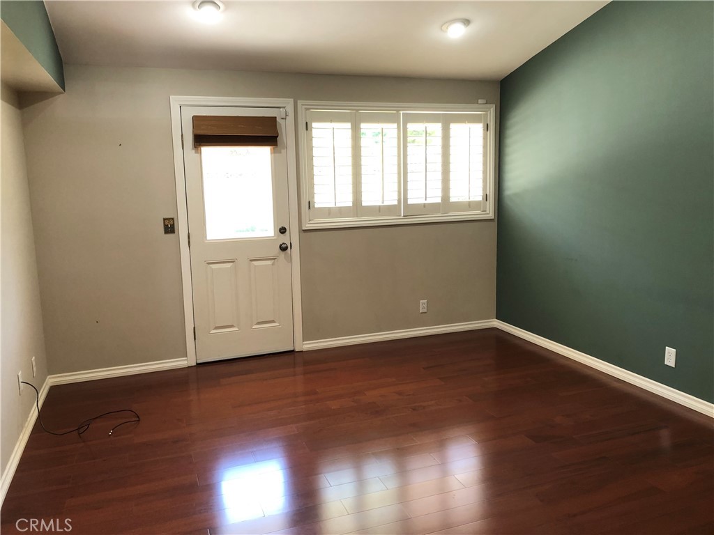 11402 Donovan Road Los Alamitos, CA 90720 - Photo 15 of 44 an empty room with wooden floor and windows