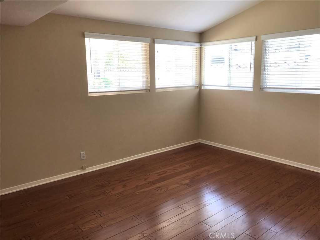 11402 Donovan Road Los Alamitos, CA 90720 - Photo 17 of 44 an empty room with wooden floor and windows