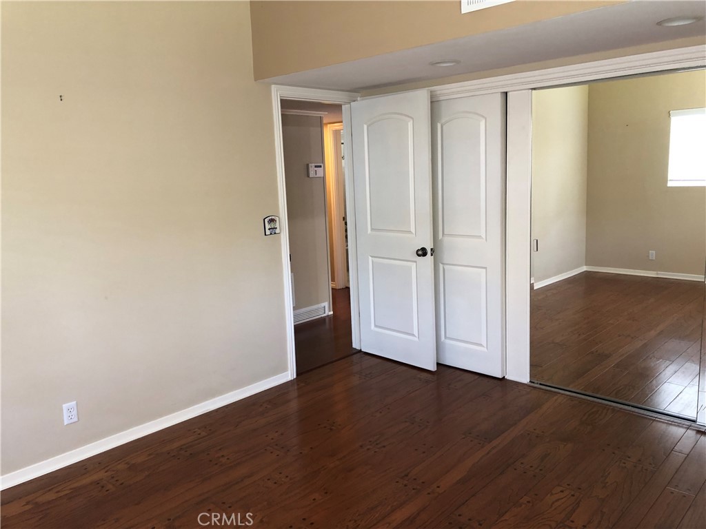 11402 Donovan Road Los Alamitos, CA 90720 - Photo 19 of 44 an empty room with wooden floor