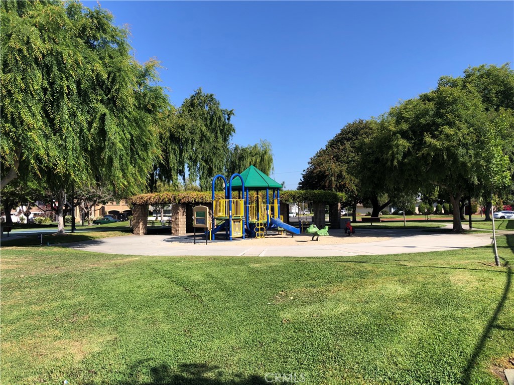 11402 Donovan Road Los Alamitos, CA 90720 - Photo 34 of 44 a view of a swimming pool with lawn chairs and a big yard
