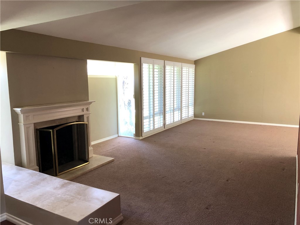 11402 Donovan Road Los Alamitos, CA 90720 - Photo 4 of 44 a view of an empty room with a fireplace and a window