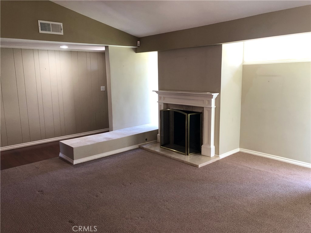11402 Donovan Road Los Alamitos, CA 90720 - Photo 5 of 44 a view of an empty room with a fireplace and a window