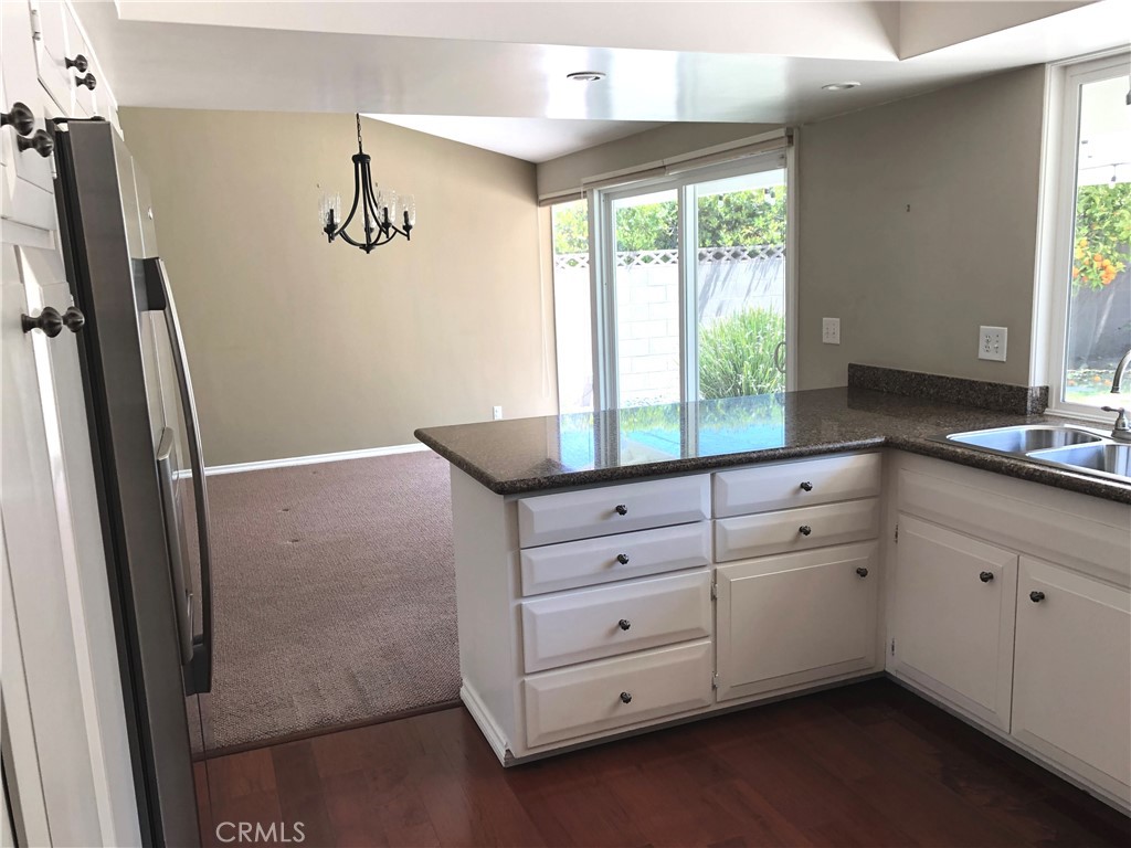 11402 Donovan Road Los Alamitos, CA 90720 - Photo 8 of 44 a kitchen with a refrigerator and window