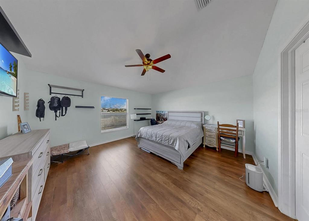 2310 Potomac Mark Place Ruskin, FL 33570 - Photo 17 of 40 a bedroom with a bed and a ceiling fan