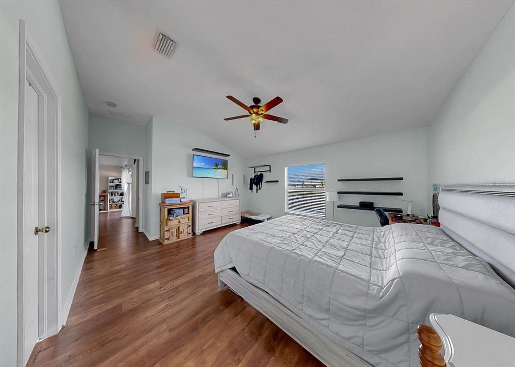 2310 Potomac Mark Place Ruskin, FL 33570 - Photo 18 of 40 a bed room with bed and a chandelier